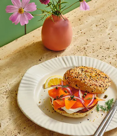Breakfast spread with bagel sandwich